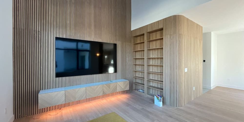 Living room featuring a wood slat accent wall and built-in shelving, styled by Interior Painters in Tampa, FL for a cohesive, modern look.
